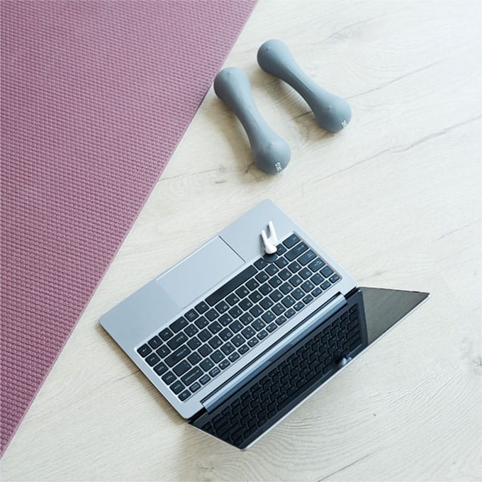 Laptop and weights ready for a virtual duet Pilates session